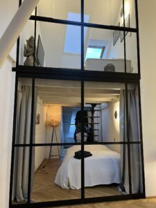 Die verglaste zweigeschossige Galerie dient als Schlaf- und Wohnraum. © Glasbau Geiger