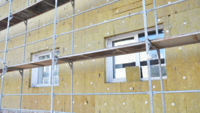 Install Rock Mineral Wool Insulation. Energy efficiency house wall renovation for energy saving. Exterior house wall heat insulation with mineral wool, building under construction.